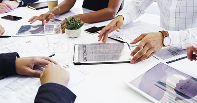 Buy stock photo Cropped shot of a group of businesspeople sitting around the boardroom table during a meeting