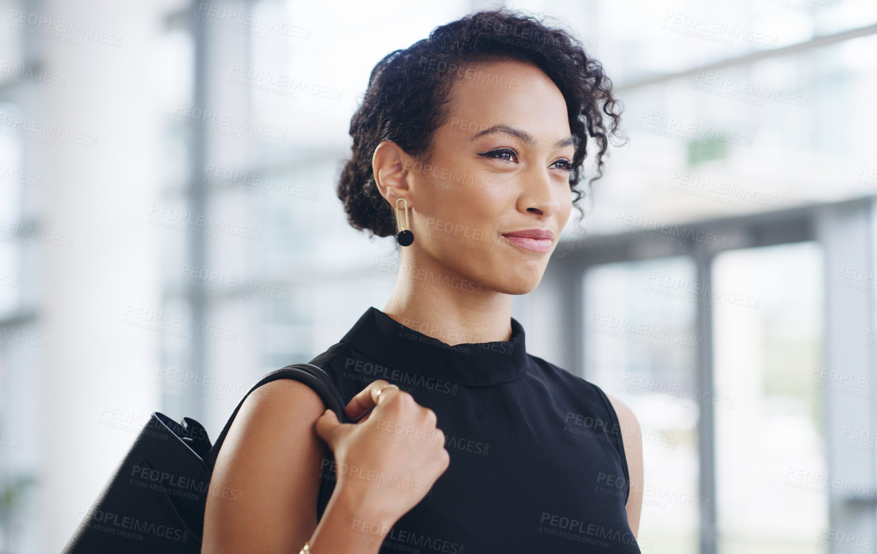 Buy stock photo Cropped shot of a confident young businesswoman walking through a modern office