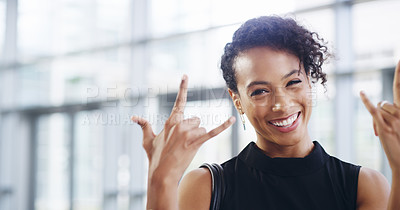 Buy stock photo Cropped shot of a young businesswoman showing a rock ’n roll sign while walking through a modern office