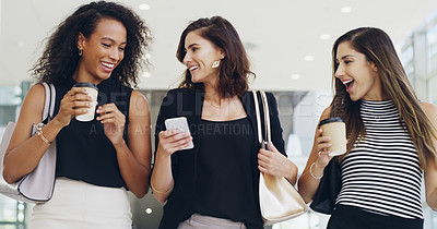 Buy stock photo Cropped shot of three young beautiful businesswomen walking through a modern office