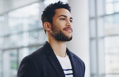 Buy stock photo Cropped shot of a young businessman showing thumbs up while walking through a modern office