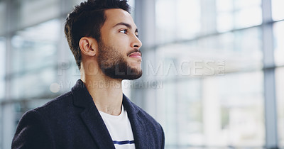 Buy stock photo Cropped shot of a young businessman showing thumbs up while walking through a modern office