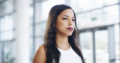 Buy stock photo Cropped shot of a confident young businesswoman walking through a modern office