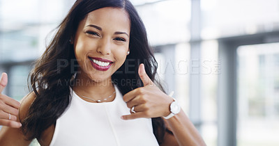 Buy stock photo Cropped shot of a young businesswoman showing thumbs up while walking through a modern office