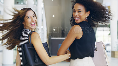 Buy stock photo Cropped shot of two beautiful young businesswomen in a modern office