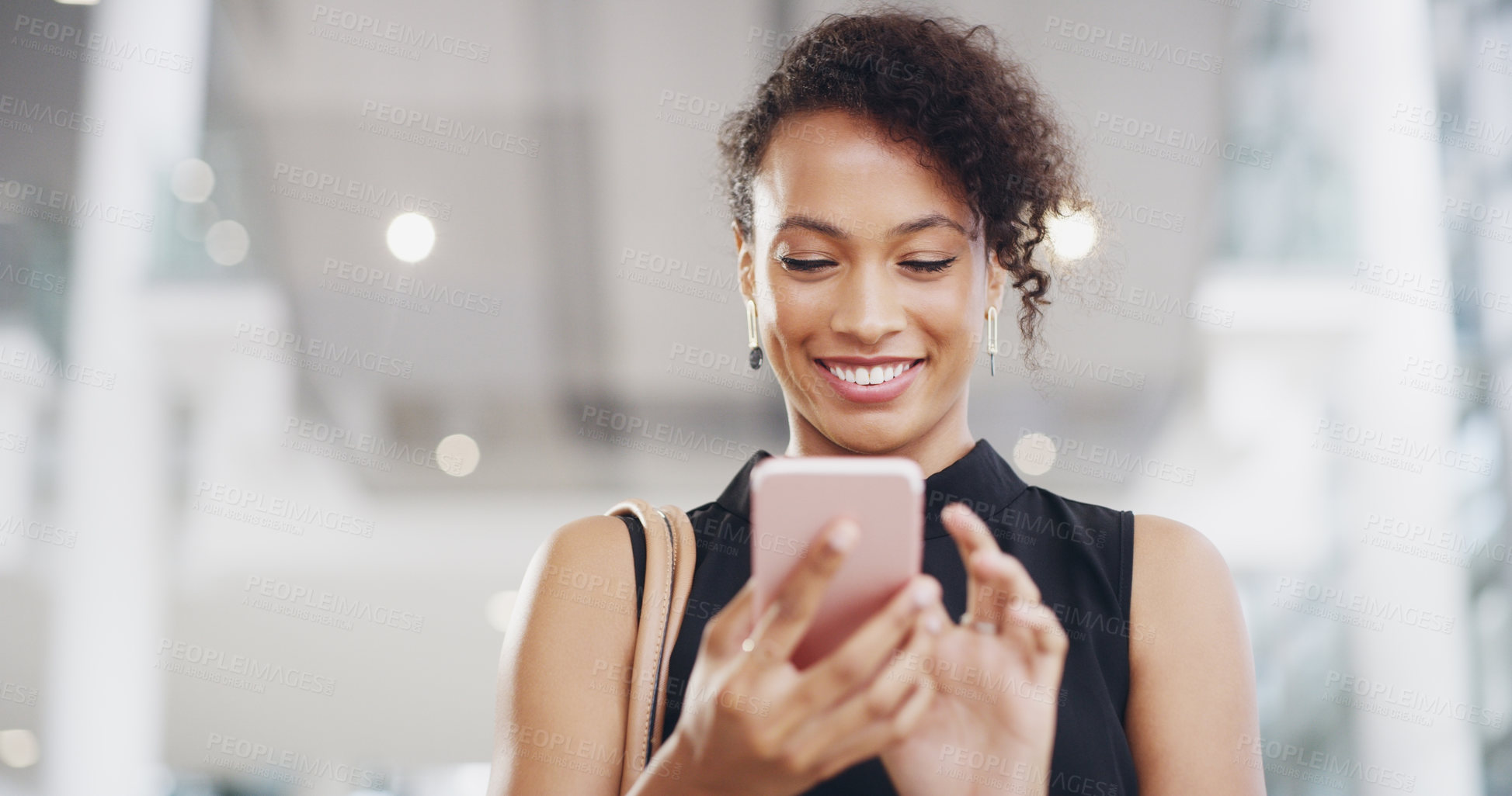 Buy stock photo Cropped shot of a young businesswoman using a smartphone and waving while walking through a modern office