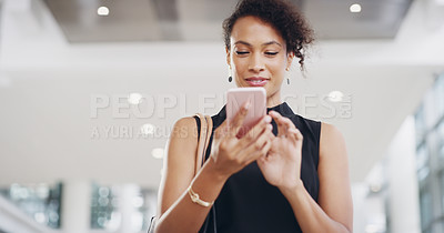 Buy stock photo Cropped shot of a young businesswoman using a smartphone and waving while walking through a modern office