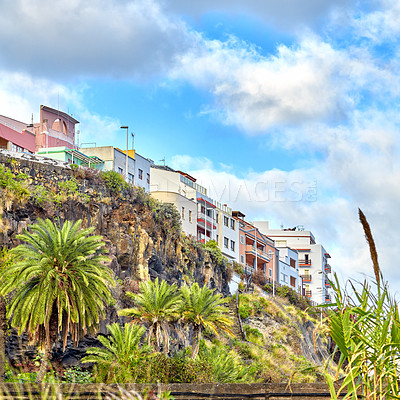 Buy stock photo Colorful old vintage buildings in Santa Cruz de La Palma. Bright and vibrant classical architecture in a small city or village. Beautiful houses or homes with a rustic design with a palm tree growing