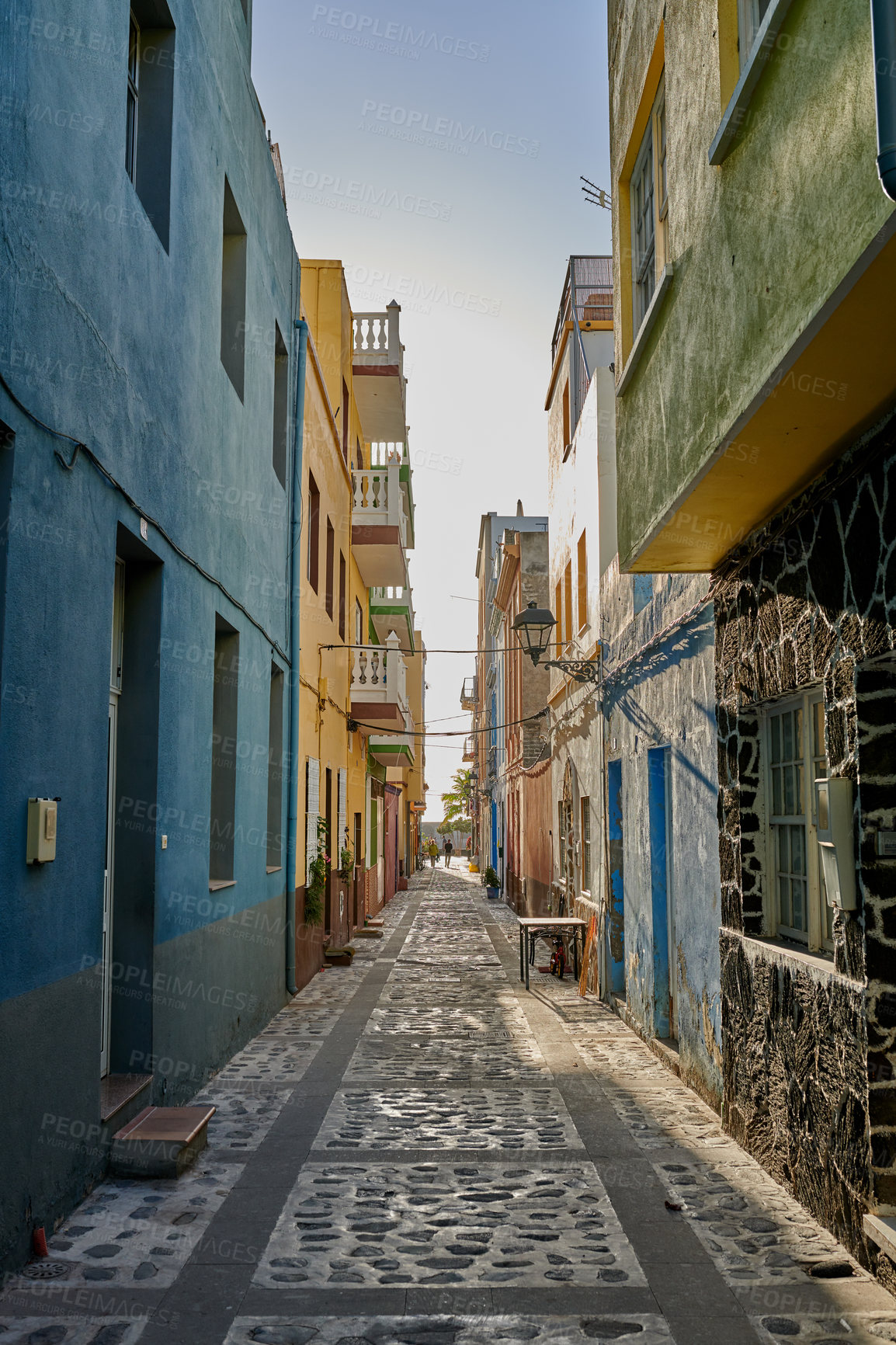 Buy stock photo Narrow street or alley between colorful buildings in Santa Cruz de La Palma. Bright and vibrant classical architecture in a small city or village. Beautiful houses or homes with a vintage design