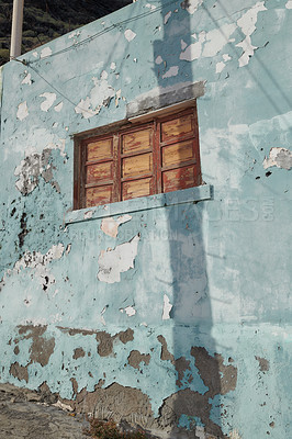 Buy stock photo Architecture of an old blue wall with peeling paint outside. Exterior texture details of an old rustic residential build with vintage wooden shut windows discovered in Santa Cruz de La Palma
