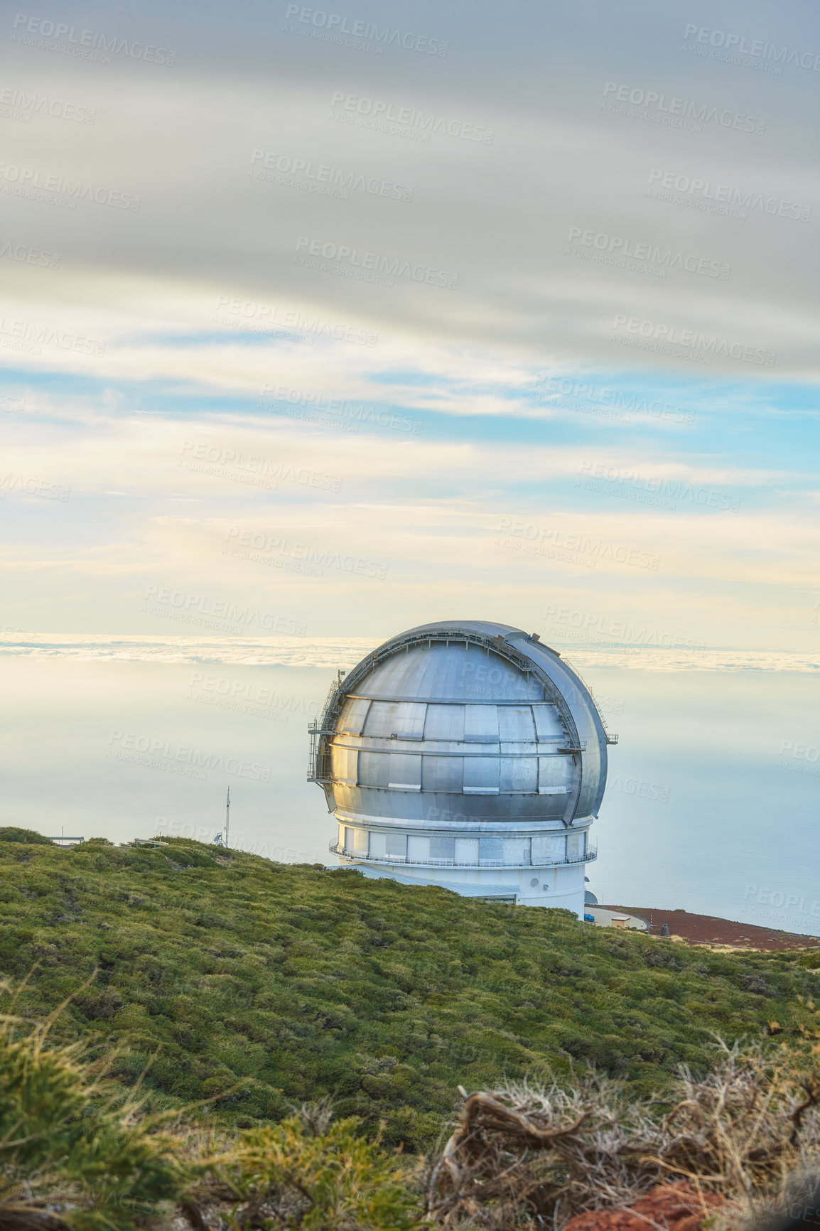 Buy stock photo Scenic view of an astronomy observatory dome in Roque de los Muchachos, La Palma, Spain. Landscape of science infrastructure or building against blue sky with clouds and copyspace abroad or overseas