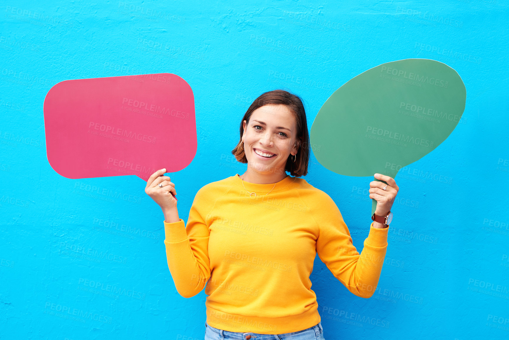 Buy stock photo Portrait, woman and smile with speech bubble in studio for social media feedback, announcement and news. Happy, girl and advertising poster for coming soon, sign up and opportunity on blue background