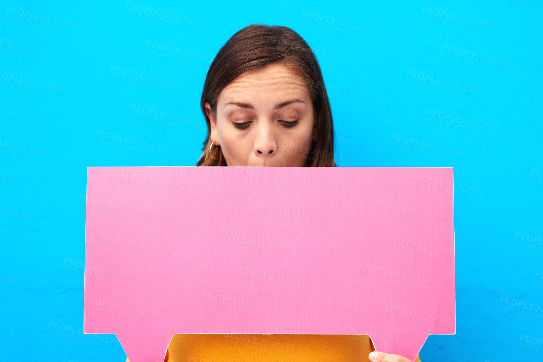 Buy stock photo Surprise, woman and smile with speech bubble in studio for social media feedback, announcement and news. Shock, girl and advertising poster for coming soon, sign up and opportunity on blue background