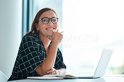 Buy stock photo Cropped portrait of a happy young businesswoman working on a laptop in an office