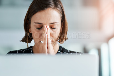 Buy stock photo Cropped shot of young businesswoman with hands clasped in prayer while working in an office
