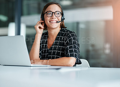 Buy stock photo Cropped shot of a happy young call centre agent working on a laptop in an office