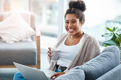 Buy stock photo Cropped portrait of an attractive young woman using her laptop and having coffee in her living room