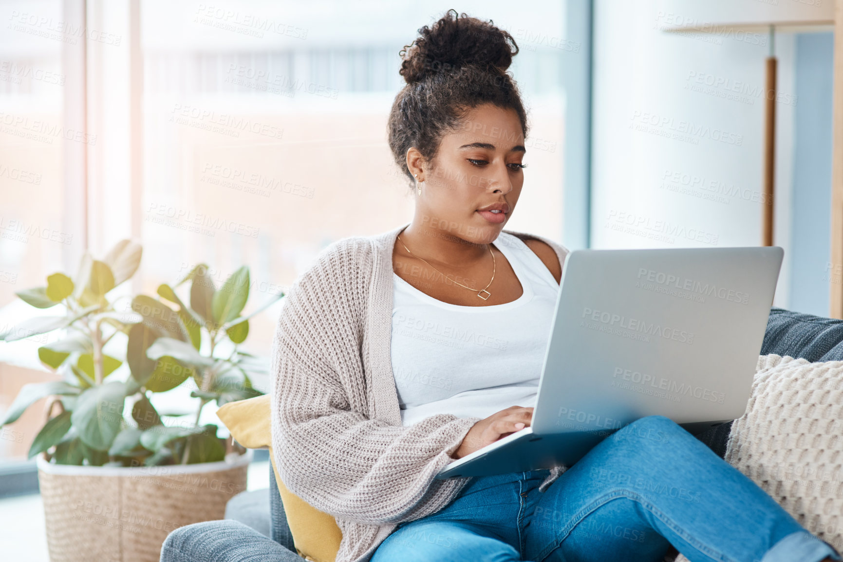 Buy stock photo Woman, laptop and on home sofa while typing email or communication. Real female person relax on a couch with internet connection and tech to chat on social media, website or do online shopping