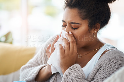Buy stock photo Sick, cold and a woman blowing nose on sofa with covid, virus or allergies in a house. Flu, healthy and a young lady with an allergy, sinus problem or sneezing into a tissue on the living room couch