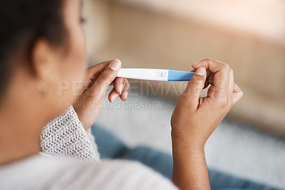 Buy stock photo Pregnancy test, woman hands and waiting at home for results on a living room couch. House, female person and hand with testing stick to show pregnant sign while checking alone on lounge sofa 