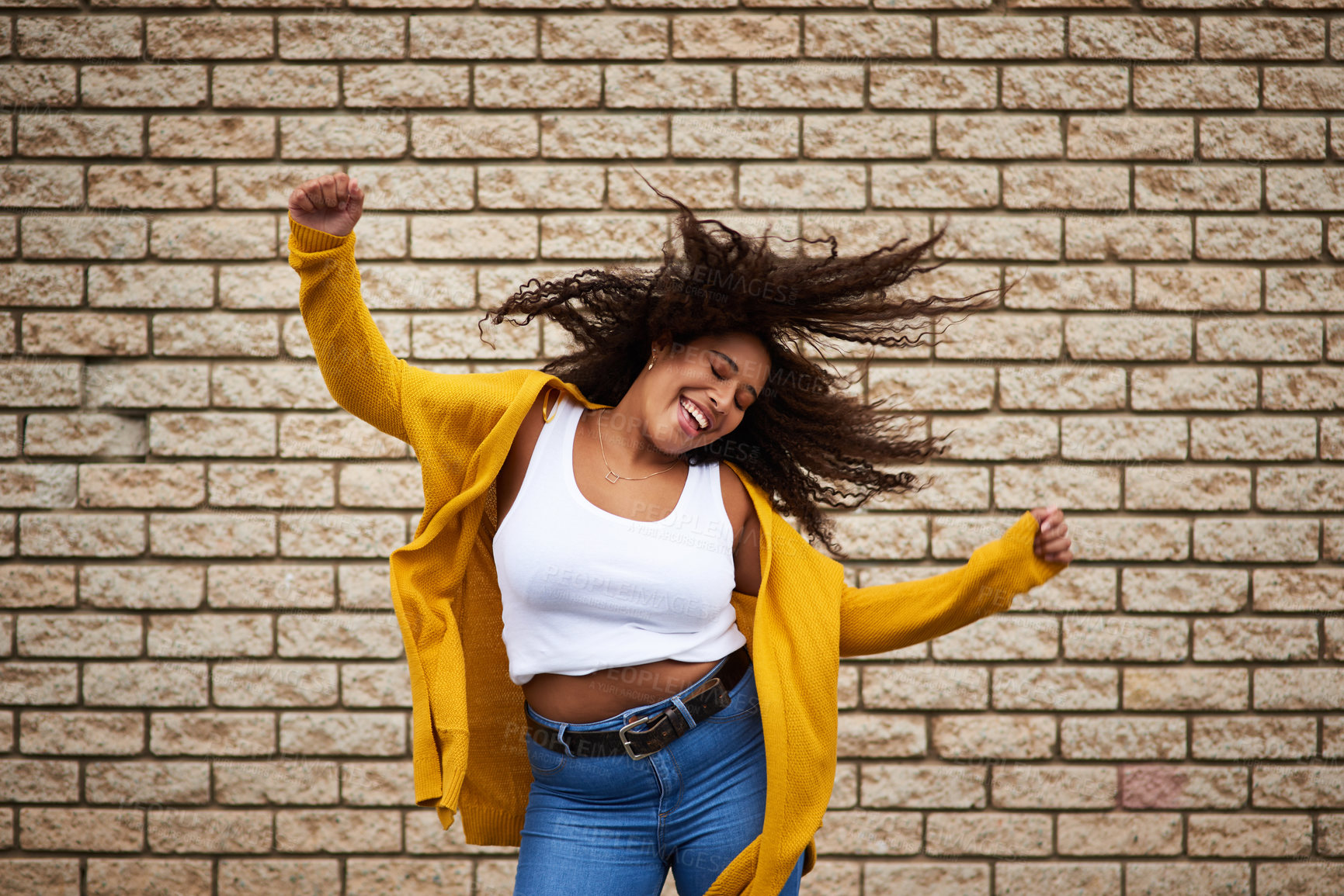 Buy stock photo Excited, girl and dancing with hair flip for playful movement, energy and fun celebration of fashion winner. Happy, woman and rhythm for success, freedom and deal achievement on brick wall background