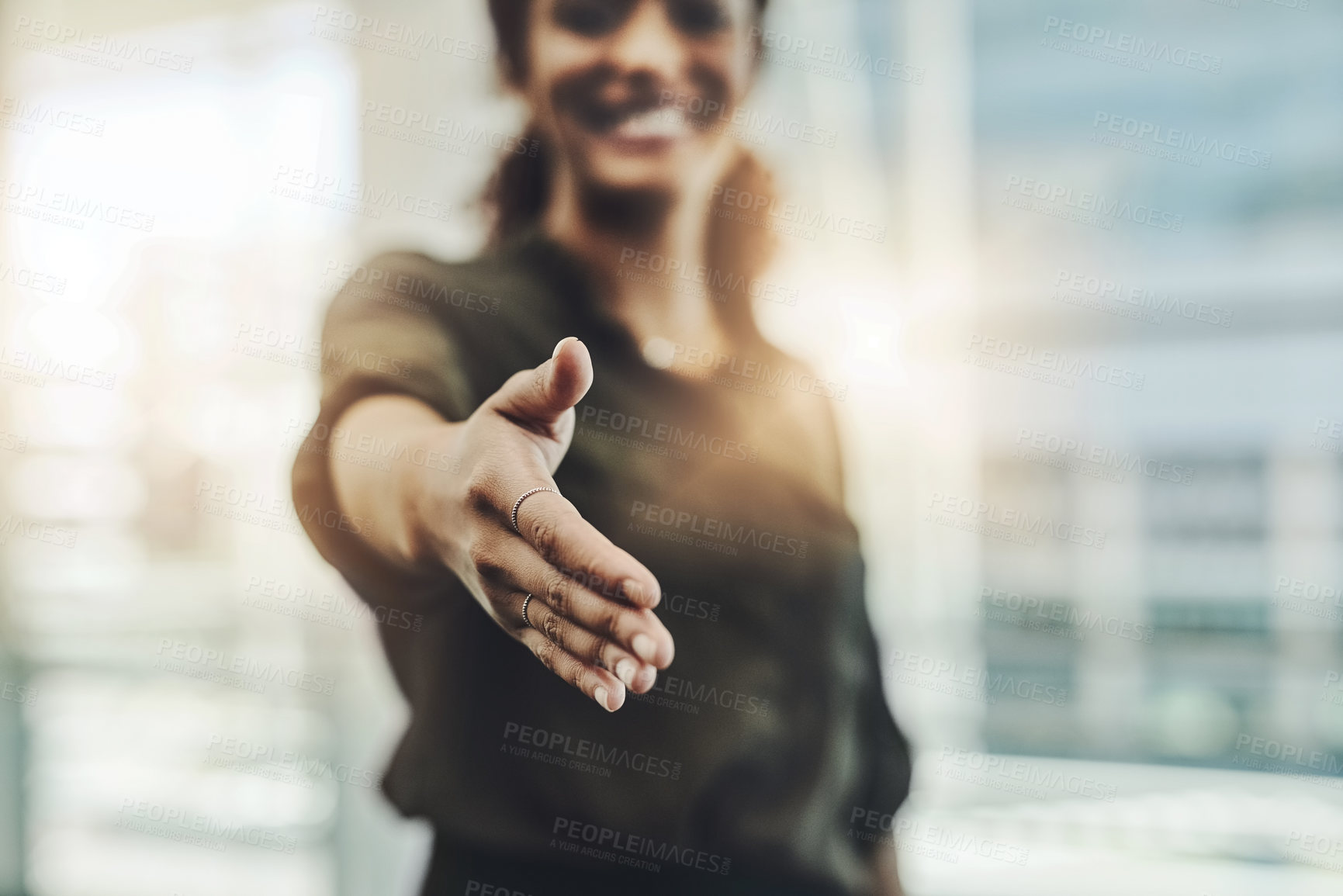 Buy stock photo Cropped shot of an unrecognizable businesswoman gesturing a handshake in a modern office