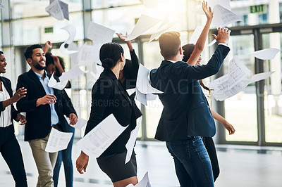 Buy stock photo Shot of a group of cheerful businesspeople lifting their hands in joy while being funny inside of the office at work