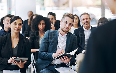 Buy stock photo Shot of a group of businesspeople sitting in the conference room during a seminar