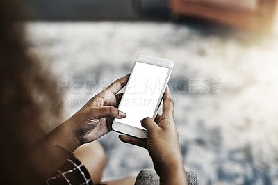 Buy stock photo High angle shot of an unrecognizable businesswoman using a smartphone in a modern office