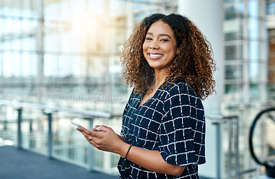 Buy stock photo Cropped portrait of an attractive young businesswoman using a smartphone in a modern office