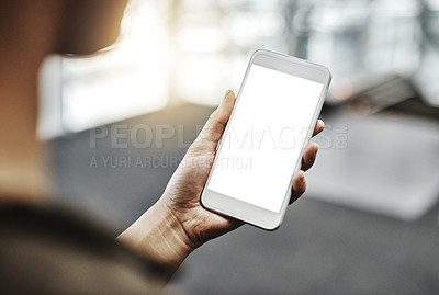 Buy stock photo Cropped shot of an unrecognizable businesswoman using a smartphone in a modern office