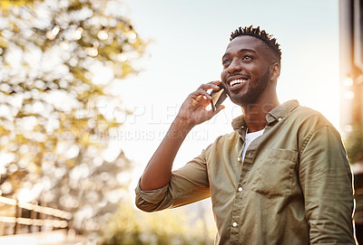 Buy stock photo Cropped shot of a handsome young man using his cellphone while standing outside