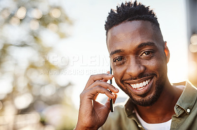 Buy stock photo Cropped portrait of a handsome young man using his cellphone while standing outside