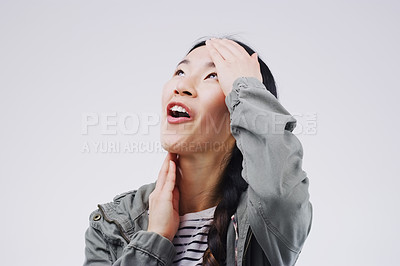 Buy stock photo Studio shot of an attractive young woman looking surprised against a grey background