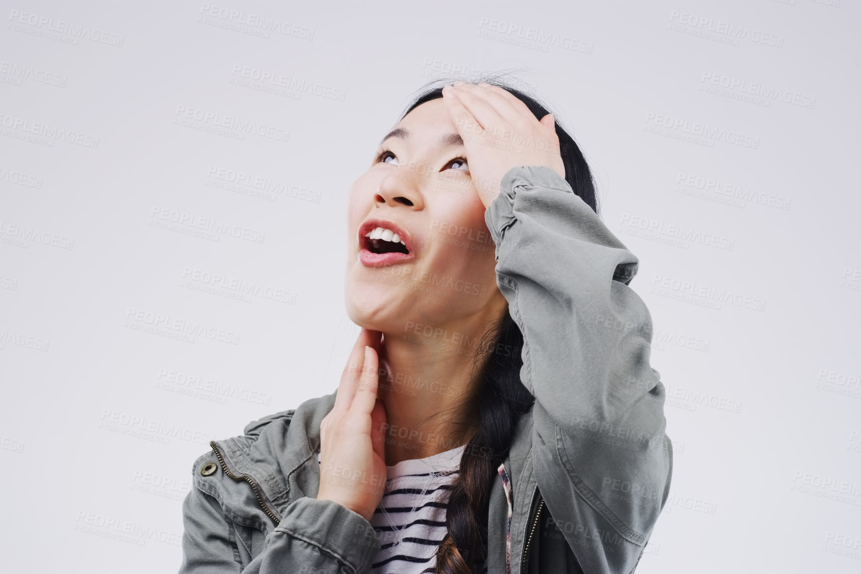 Buy stock photo Studio shot of an attractive young woman looking surprised against a grey background