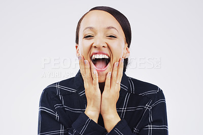 Buy stock photo Studio portrait of an attractive young woman looking surprised against a grey background