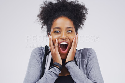 Buy stock photo Studio portrait of an attractive young woman looking surprised against a grey background