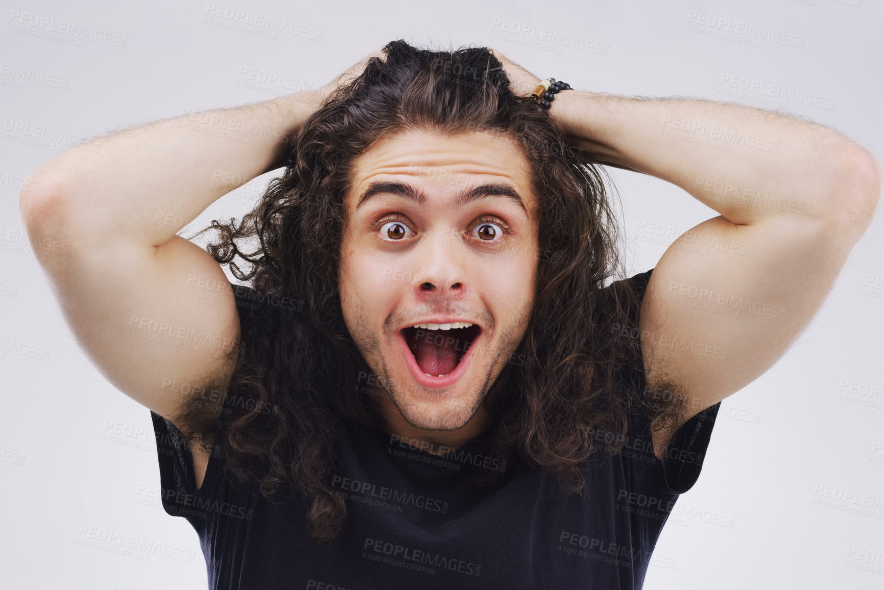 Buy stock photo Studio portrait of a handsome young man looking surprised against a grey background