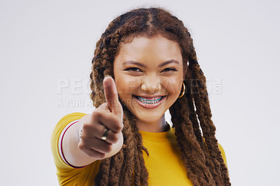Buy stock photo Woman, studio portrait and smile with thumbs up for agreement, vote or hand for review with happiness by background. Girl, model and sign for opinion, yes or thank you for motivation, win and success