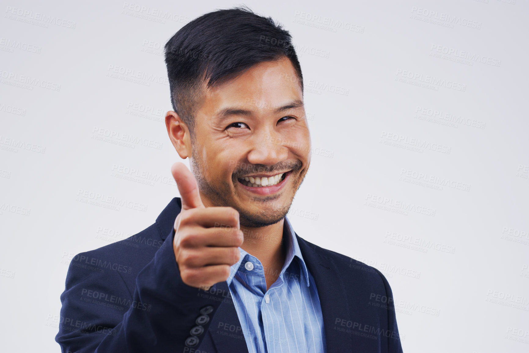 Buy stock photo Studio portrait of a handsome young businessman giving a thumbs up against a grey background