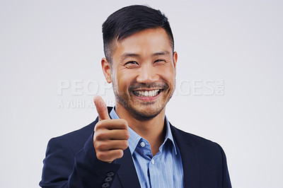 Buy stock photo Studio portrait of a handsome young businessman giving a thumbs up against a grey background