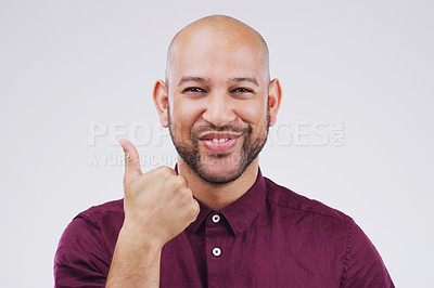 Buy stock photo Studio portrait of a handsome young man giving a thumbs up against a grey background