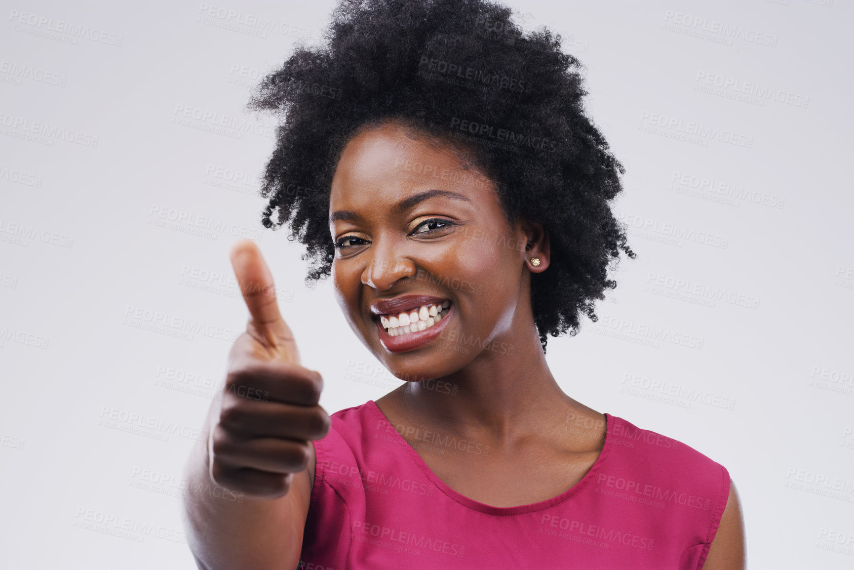 Buy stock photo Studio portrait of an attractive young woman giving a thumbs up against a grey background