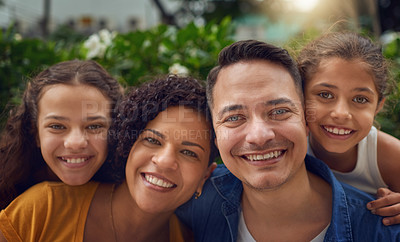 Buy stock photo Cropped portrait of a happy family spending some time together at the park