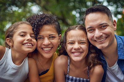 Buy stock photo Cropped portrait of a happy family spending some time together at the park