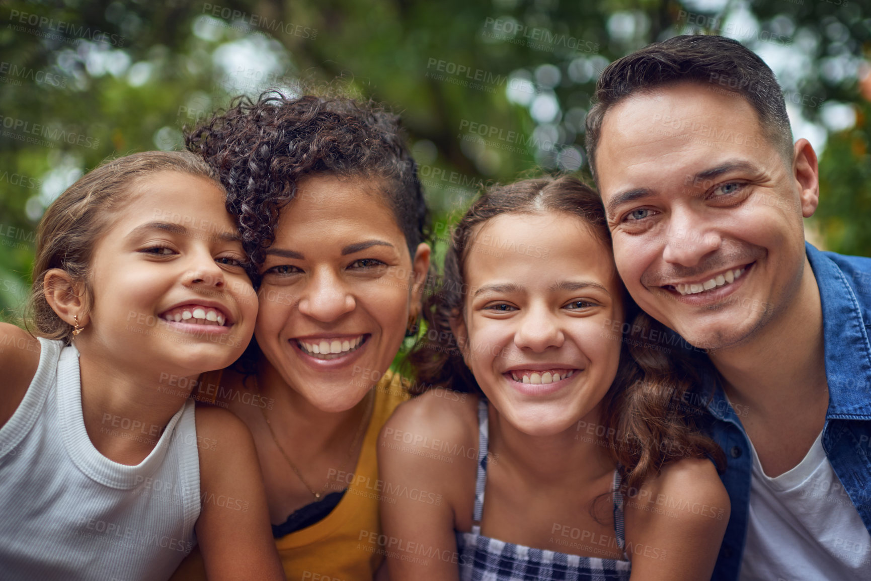 Buy stock photo Cropped portrait of a happy family spending some time together at the park