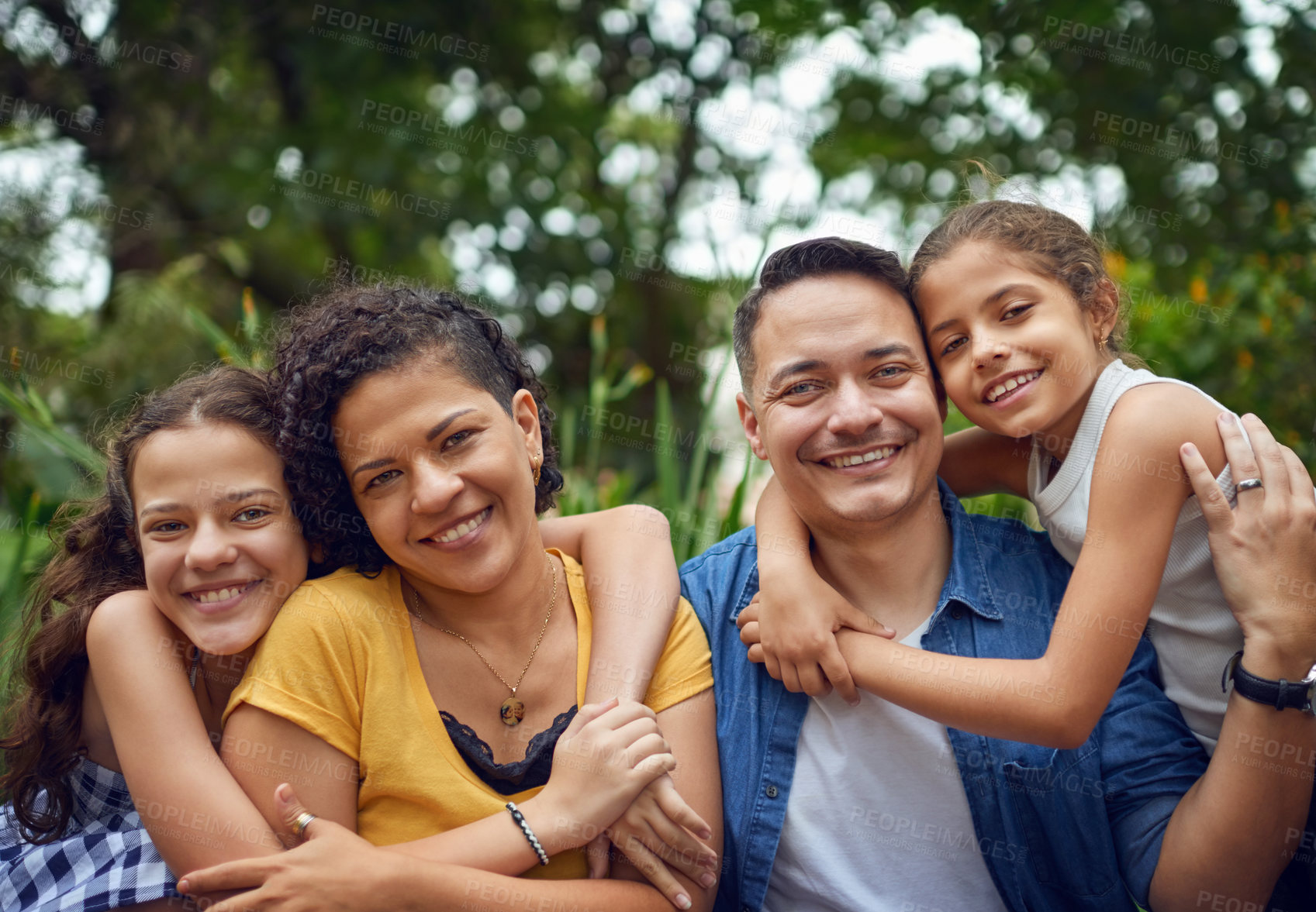 Buy stock photo Cropped portrait of a happy family spending some time together at the park