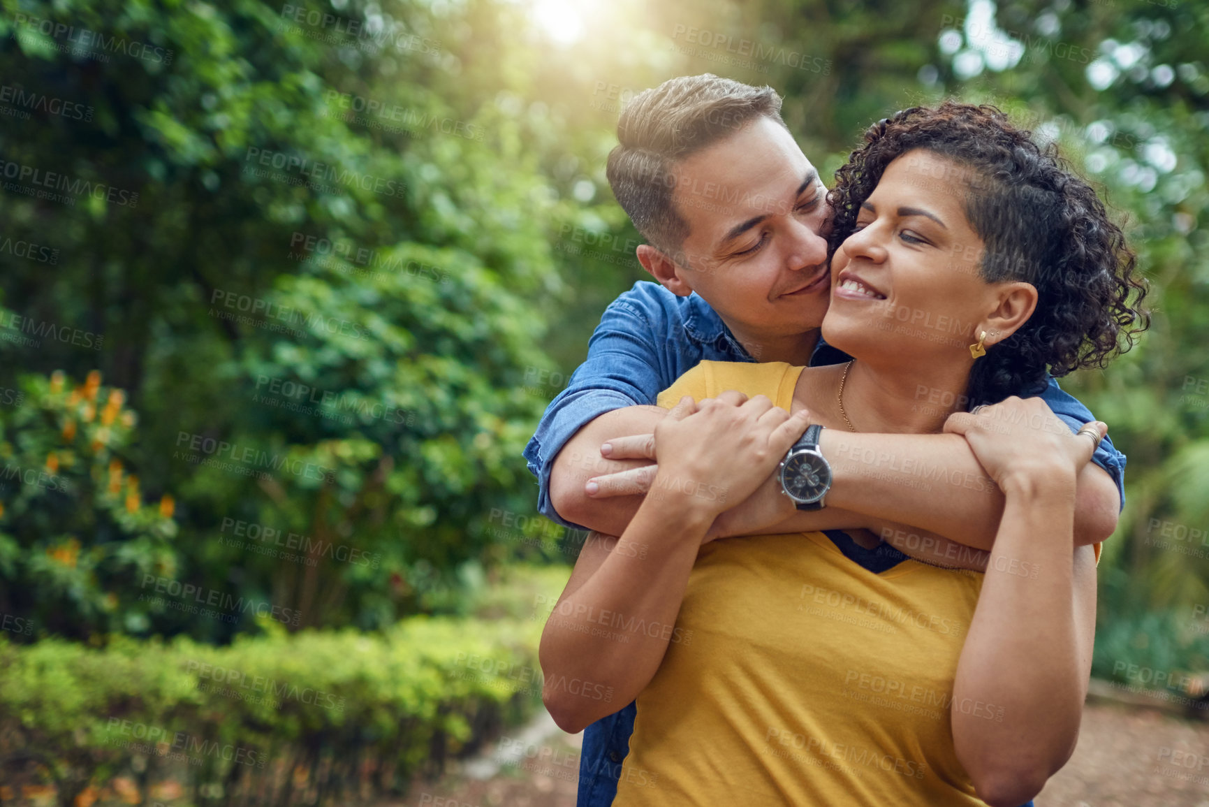 Buy stock photo Cropped shot of an affectionate couple embracing each other at the park