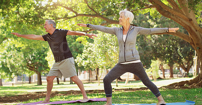 Buy stock photo Full length shot of a happy senior couple doing yoga together at the park