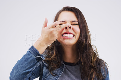 Buy stock photo Smile, funny face and nose with a crazy woman in studio on a white background for carefree humor. Comic, comedy and showing nostrils with a weird young female person feeling playful while joking